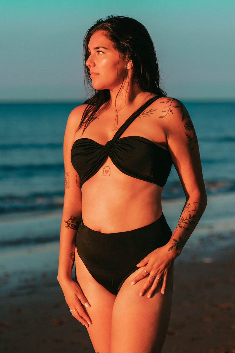 Callie Croken, a life and business coach, sipping coffee playfully in a window sill during her branding photoshoot with Lake Design.